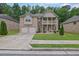 Charming two-story brick home featuring a double-door garage and welcoming front porch and upstairs balcony at 412 Live Oak Pass, Loganville, GA 30052