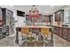 Beautiful kitchen island with granite countertops, seating, and hanging pot rack at 412 Live Oak Pass, Loganville, GA 30052