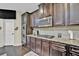Kitchen features dark wood cabinets, stainless steel appliances, and granite countertops at 412 Live Oak Pass, Loganville, GA 30052