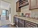 Kitchen with beverage bar featuring dark cabinets, granite countertops, and wine rack at 412 Live Oak Pass, Loganville, GA 30052