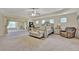 Spacious main bedroom with large bed, sitting area, and tray ceiling at 412 Live Oak Pass, Loganville, GA 30052