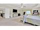 Spacious primary bedroom features a tray ceiling, neutral carpet, and large windows for plenty of natural light at 412 Live Oak Pass, Loganville, GA 30052