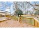Expansive wooden backyard deck, perfect for outdoor entertaining with a lush lawn and mature trees at 2328 Carnes Rd, Jonesboro, GA 30236