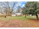 Spacious backyard view featuring a well-maintained lawn, mature trees, and a wooden deck at 2328 Carnes Rd, Jonesboro, GA 30236