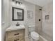 Stylish bathroom with light wood vanity, gray tiled shower, and modern fixtures at 2328 Carnes Rd, Jonesboro, GA 30236