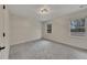 Bright, carpeted bedroom with ample natural light from two windows, ready for personal touches at 2328 Carnes Rd, Jonesboro, GA 30236