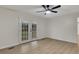 Bright bedroom with ceiling fan and French doors leading to the backyard deck, and wood flooring at 2328 Carnes Rd, Jonesboro, GA 30236