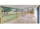 Inviting covered deck overlooking a spacious backyard with lush greenery and trees at 2328 Carnes Rd, Jonesboro, GA 30236