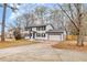 Charming two-story home with a white exterior, black shutters, and attached garage at 2328 Carnes Rd, Jonesboro, GA 30236