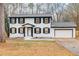 Charming two-story home with a white exterior, black shutters, and attached garage at 2328 Carnes Rd, Jonesboro, GA 30236