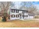 Charming two-story home with a white exterior, black shutters, and attached garage at 2328 Carnes Rd, Jonesboro, GA 30236