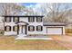 Charming two-story home with a white exterior, black shutters, and attached garage at 2328 Carnes Rd, Jonesboro, GA 30236