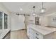Open kitchen concept featuring an island, a sliding barn door and stainless steel appliances at 2328 Carnes Rd, Jonesboro, GA 30236