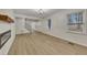 Spacious living room with luxury vinyl plank floors, fireplace, view of foyer, and natural light at 2328 Carnes Rd, Jonesboro, GA 30236