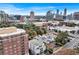 An aerial view of the property with surrounding neighborhood and city skyline in the background at 3649 Peachtree Ne Rd # 201, Atlanta, GA 30319