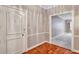 View of an entryway and hallway featuring light brown wood flooring and white trim at 3649 Peachtree Ne Rd # 201, Atlanta, GA 30319