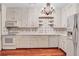 Bright kitchen features white cabinets, oven, microwave, and stainless steel sink at 3649 Peachtree Ne Rd # 201, Atlanta, GA 30319