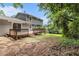 Expansive backyard with a wooden deck, offering a private outdoor space surrounded by mature trees and lush greenery at 1023 Chartley Sw Dr, Lilburn, GA 30047
