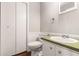 Bathroom featuring a wood floor, green countertops, and white walls at 1023 Chartley Sw Dr, Lilburn, GA 30047