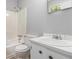 Well-lit bathroom with white vanity, sink, and a shower-tub combo perfect for relaxation at 1023 Chartley Sw Dr, Lilburn, GA 30047