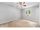 Bedroom featuring neutral walls, carpet, ceiling fan, and a window with natural light at 1023 Chartley Sw Dr, Lilburn, GA 30047