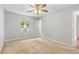 Bedroom featuring neutral walls, carpet, ceiling fan, and a window bringing in lots of natural light at 1023 Chartley Sw Dr, Lilburn, GA 30047