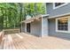 A generously sized wooden deck complements a gray siding home, offering an inviting outdoor retreat at 1023 Chartley Sw Dr, Lilburn, GA 30047
