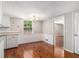 Dining area featuring wood floors, white wainscoting, a chandelier, and natural light at 1023 Chartley Sw Dr, Lilburn, GA 30047