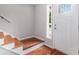 Bright entryway with hardwood floors and a white door with decorative glass at 1023 Chartley Sw Dr, Lilburn, GA 30047