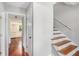 Hallway featuring hardwood floors, fresh paint, and a staircase at 1023 Chartley Sw Dr, Lilburn, GA 30047