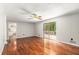 Large living room featuring hardwood floors, neutral walls, sliding door to the deck, open to the kitchen at 1023 Chartley Sw Dr, Lilburn, GA 30047