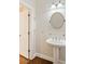 Bathroom features a pedestal sink, brushed nickel accents, and wood floors at 1266 Creekside Se Ter, Smyrna, GA 30082