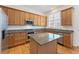 Modern kitchen featuring granite countertops, stainless steel appliances, a kitchen island, and natural wood cabinets at 1266 Creekside Se Ter, Smyrna, GA 30082