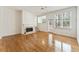 Spacious living room with hardwood floors, fireplace, and views of the backyard at 1266 Creekside Se Ter, Smyrna, GA 30082