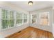 Cozy sunroom bathed in natural light, with multiple windows offering serene views. Hardwood flooring at 1266 Creekside Se Ter, Smyrna, GA 30082