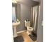 Full bathroom featuring pedestal sink, tile floor, and shower with curtain at 4701 Flat Shoals Rd # 37E, Union City, GA 30291