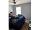 Bedroom with a ceiling fan, large window, and a comfortable bed at 4701 Flat Shoals Rd # 37E, Union City, GA 30291