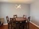 Dining room features a wood table with chairs, modern light fixture, and hardwood floors at 4701 Flat Shoals Rd # 37E, Union City, GA 30291