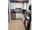 View of kitchen with white cabinets, stainless steel appliances, and tile floors at 4701 Flat Shoals Rd # 37E, Union City, GA 30291