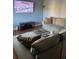 Spacious living room featuring hardwood floors, sectional sofa, and a wall mounted tv at 4701 Flat Shoals Rd # 37E, Union City, GA 30291