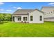 Backyard features a covered patio and a large, lush lawn, perfect for entertaining and relaxation at 1101 Cooks Farm Way, Woodstock, GA 30189