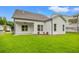 The backyard features a covered porch with a ceiling fan and a lawn area with views of neighboring homes at 1101 Cooks Farm Way, Woodstock, GA 30189