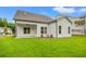 Covered patio and lush lawn enhances this home's backyard, creating an ideal outdoor oasis at 1101 Cooks Farm Way, Woodstock, GA 30189