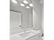 Bathroom with a white single sink vanity, sleek faucet, and modern lighting at 1101 Cooks Farm Way, Woodstock, GA 30189