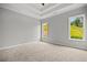 Bedroom featuring a tray ceiling and large windows allowing natural light to flood the space at 1101 Cooks Farm Way, Woodstock, GA 30189