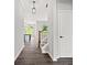 Welcoming entryway with hardwood floors leads to a staircase and view of the open-concept kitchen at 1101 Cooks Farm Way, Woodstock, GA 30189