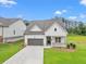 Attractive home with a well-maintained lawn, covered entry, and an attached garage at 1101 Cooks Farm Way, Woodstock, GA 30189