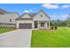 Charming one-story home featuring a well-manicured lawn, covered porch, and attached garage at 1101 Cooks Farm Way, Woodstock, GA 30189