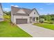 Charming home with a well-manicured lawn, complemented by a two-car garage and tasteful landscaping at 1101 Cooks Farm Way, Woodstock, GA 30189