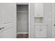 Hallway with utility area with cabinets, drawers and shelving, plus a storage closet at 1101 Cooks Farm Way, Woodstock, GA 30189